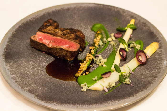 Gabriel Kreuther 7X Colorado Wagyu Beef Strip Loin, asparagus, cabrales blue, hazelnut crumble (supplement $25) 