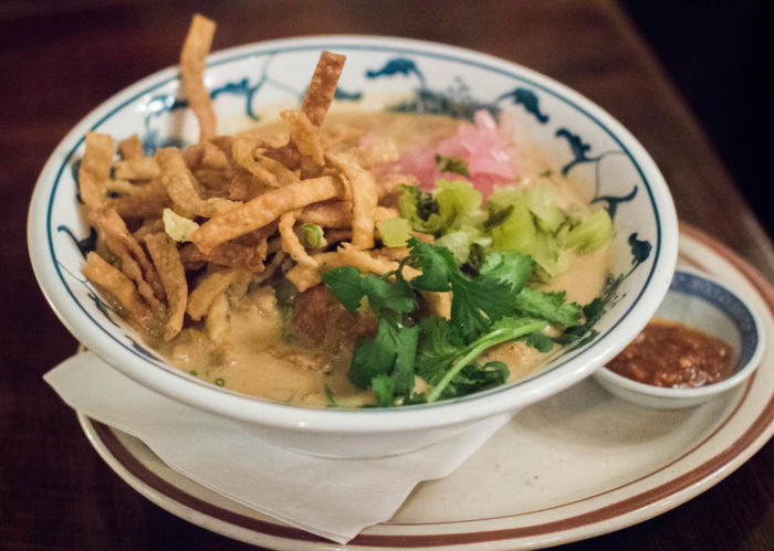 Hearty & delicious Khao Soi Kaa Kai, Northern style curry with homemade egg noodles, chicken leg, pickled mustard greens and fresh turmeric - $22